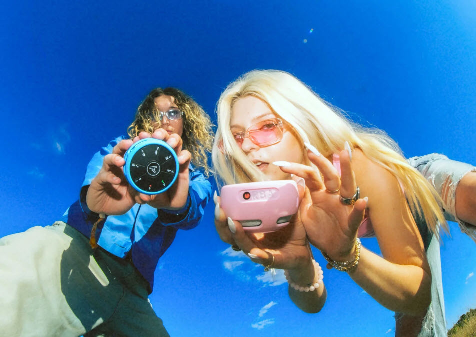 image of two people, each playing Orba3 musical instruments